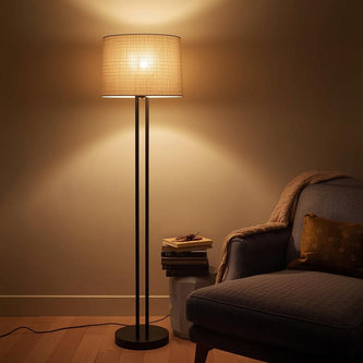 Living room corner with a tall floor lamp and armchair.
